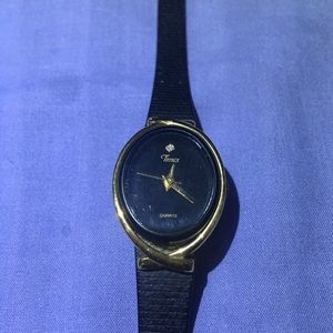 1980’s Ladies Timex wristwatch. Black with gold trim & diamond @ 12:00. /018
